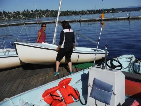 Two sailors lifting an FJ at the dock