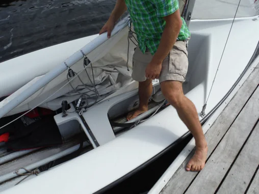 Sailor stepping into the middle of an FJ