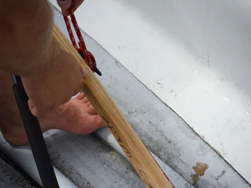 Securing line tied to the cleat on the tiller