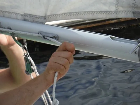 Sailor tightening the outhaul