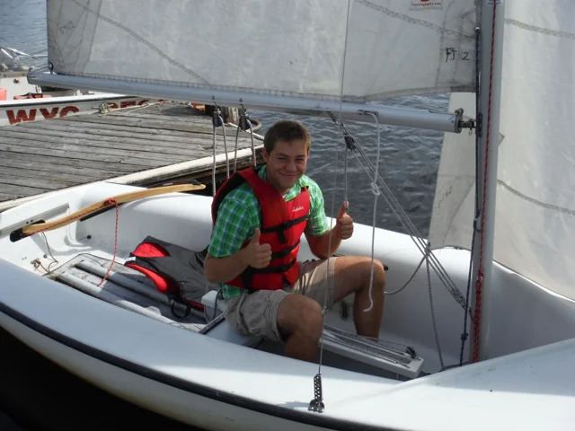 Sailor wearing a PFD in a fully rigged FJ