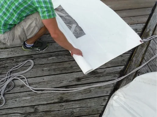 Sailor starting to roll the jib