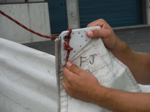 Figure-eight stopper knot securing the FJ halyard through the sail headboard.